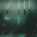Steam condensation and water streaks on a glass panel