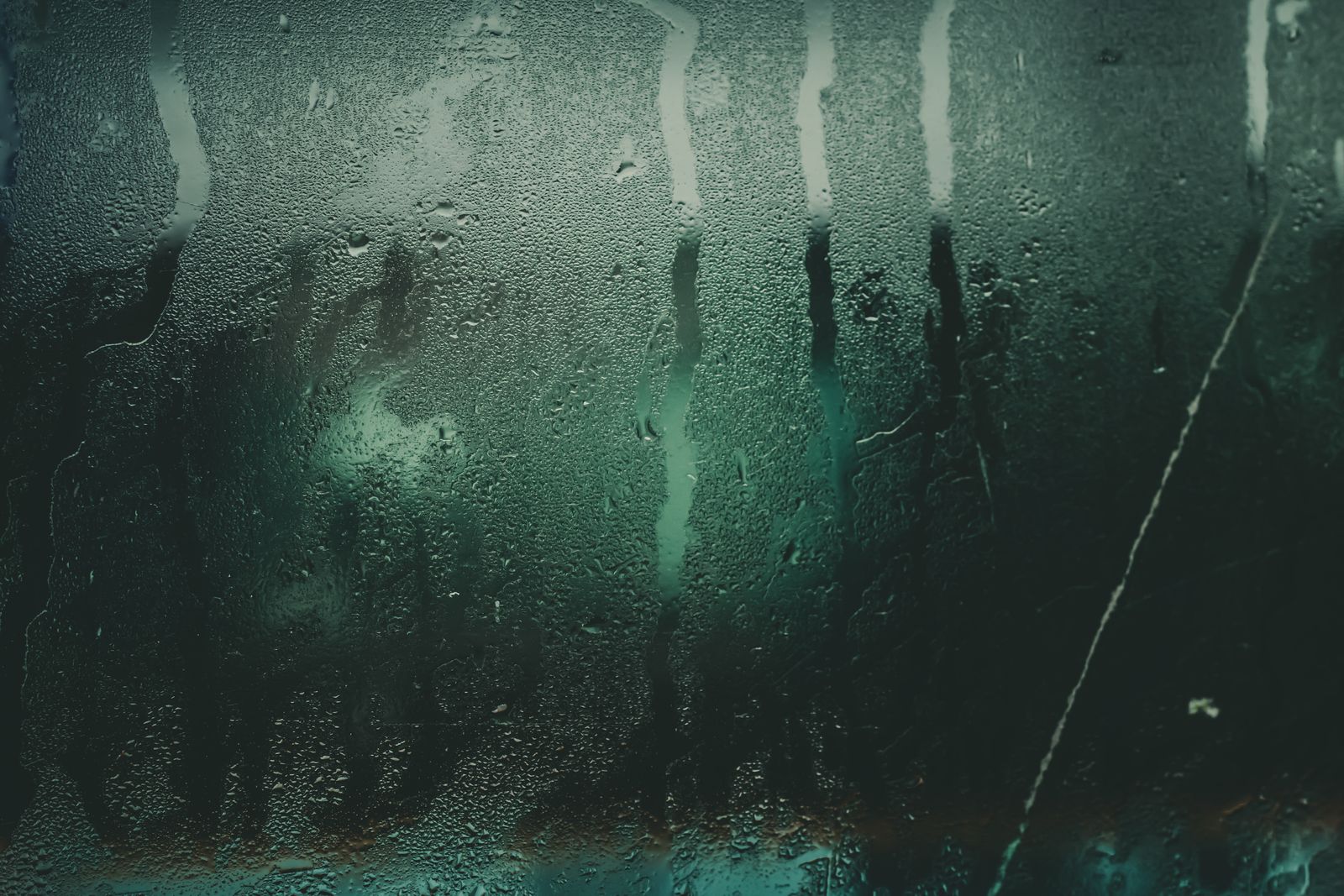 Steam condensation and water streaks on a glass panel
