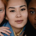Close-up portrait of three women with different skin tones and types