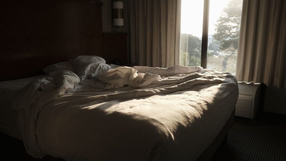 Morning sunlight falling across a bed