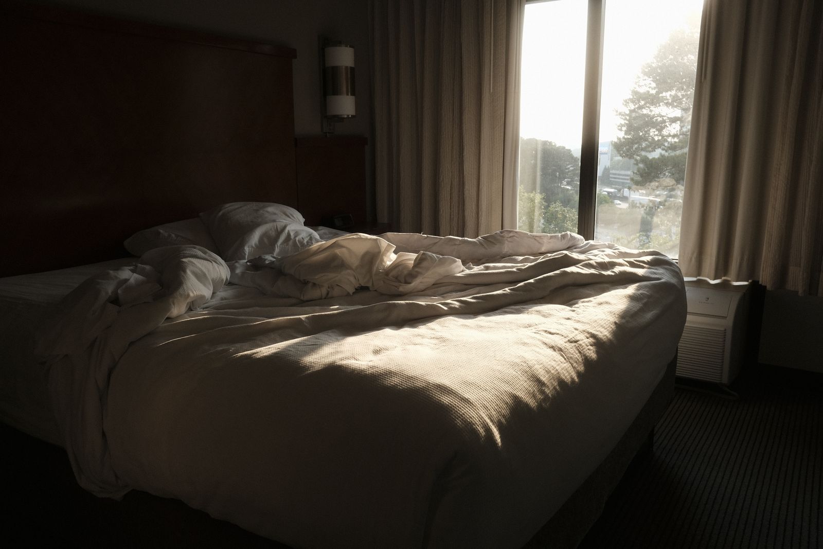 Morning sunlight falling across a bed