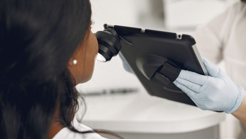 Dermatologist examining a patient’s skin with a dermatoscope