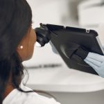 Dermatologist examining a patient’s skin with a dermatoscope