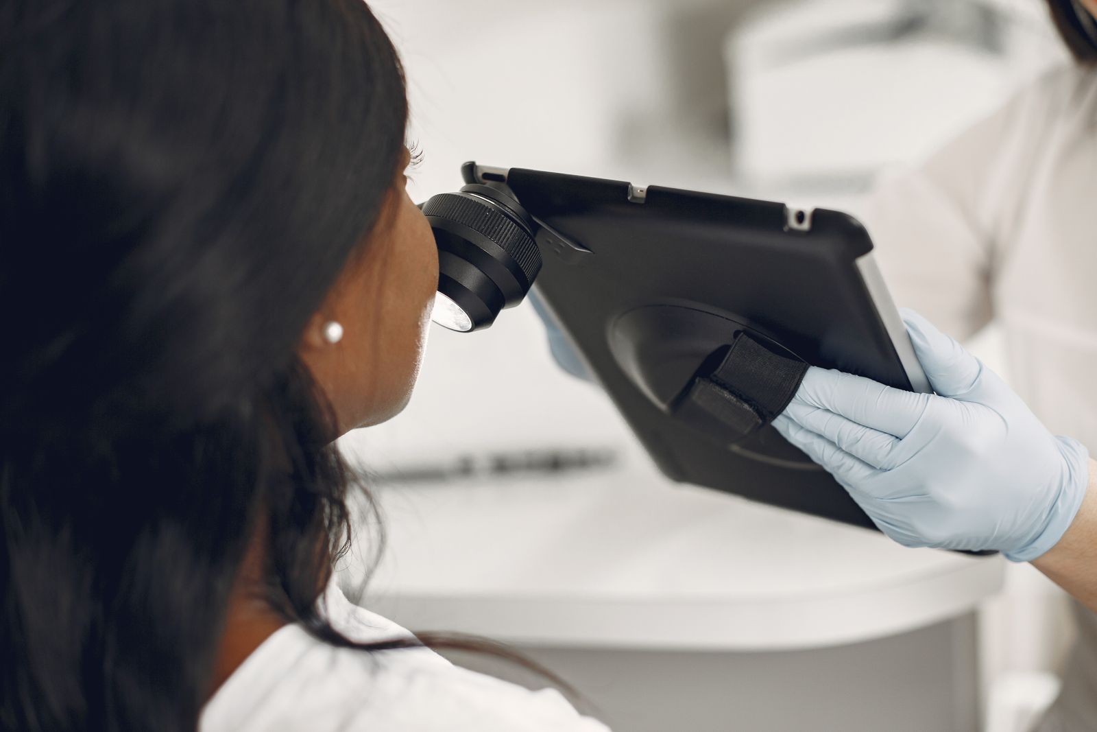 Dermatologist examining a patient’s skin with a dermatoscope