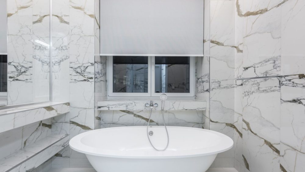 Marble bathroom interior with a freestanding bath