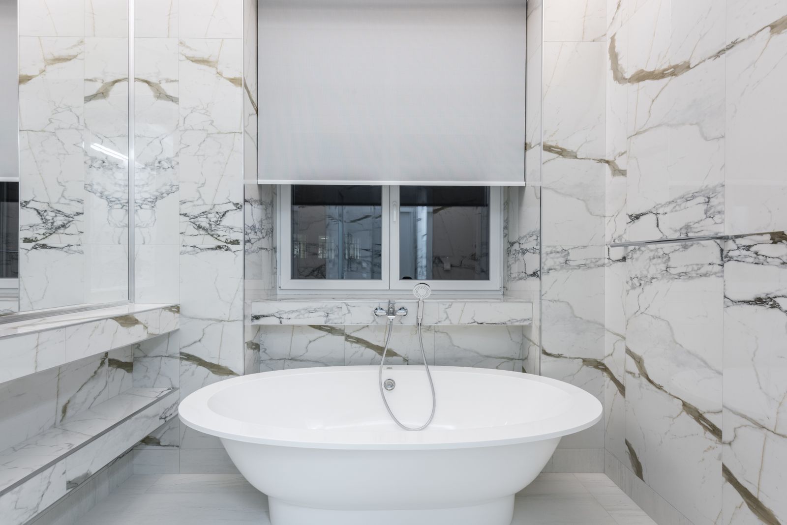 Marble bathroom interior with a freestanding bath