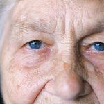 Close-up portrait of an older woman with the eye area in focus