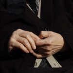 Close-up of an older woman’s clasped hands