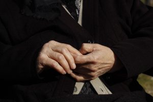 Close-up of an older woman’s clasped hands