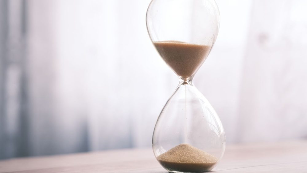 Sand running through an hourglass