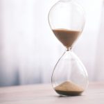 Sand running through an hourglass