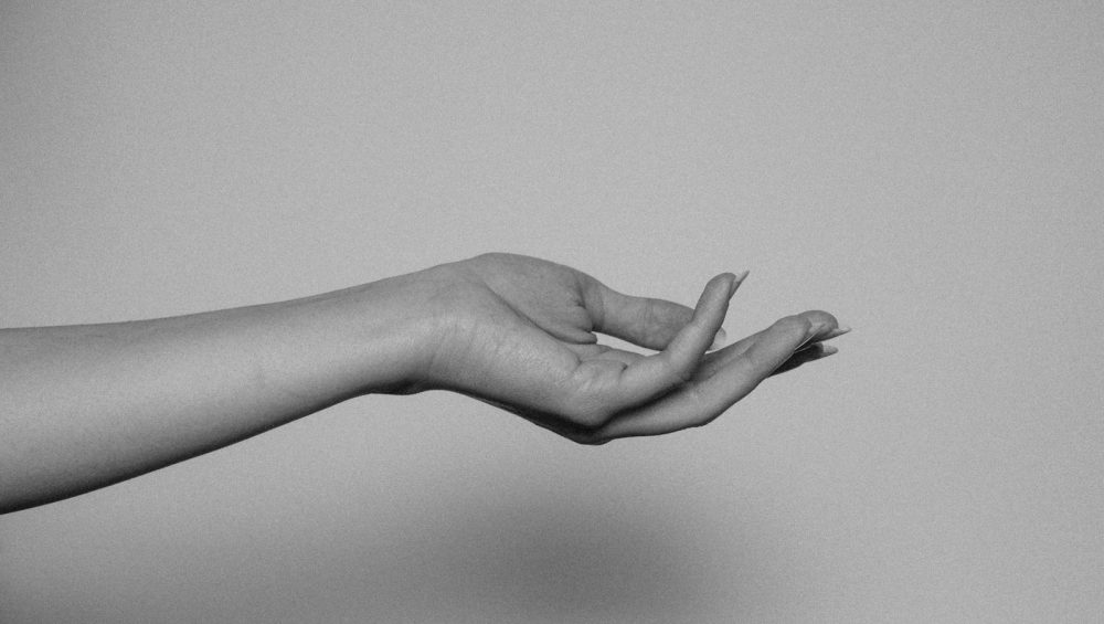 An outstretched inner forearm and open hand