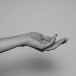 An outstretched inner forearm and open hand