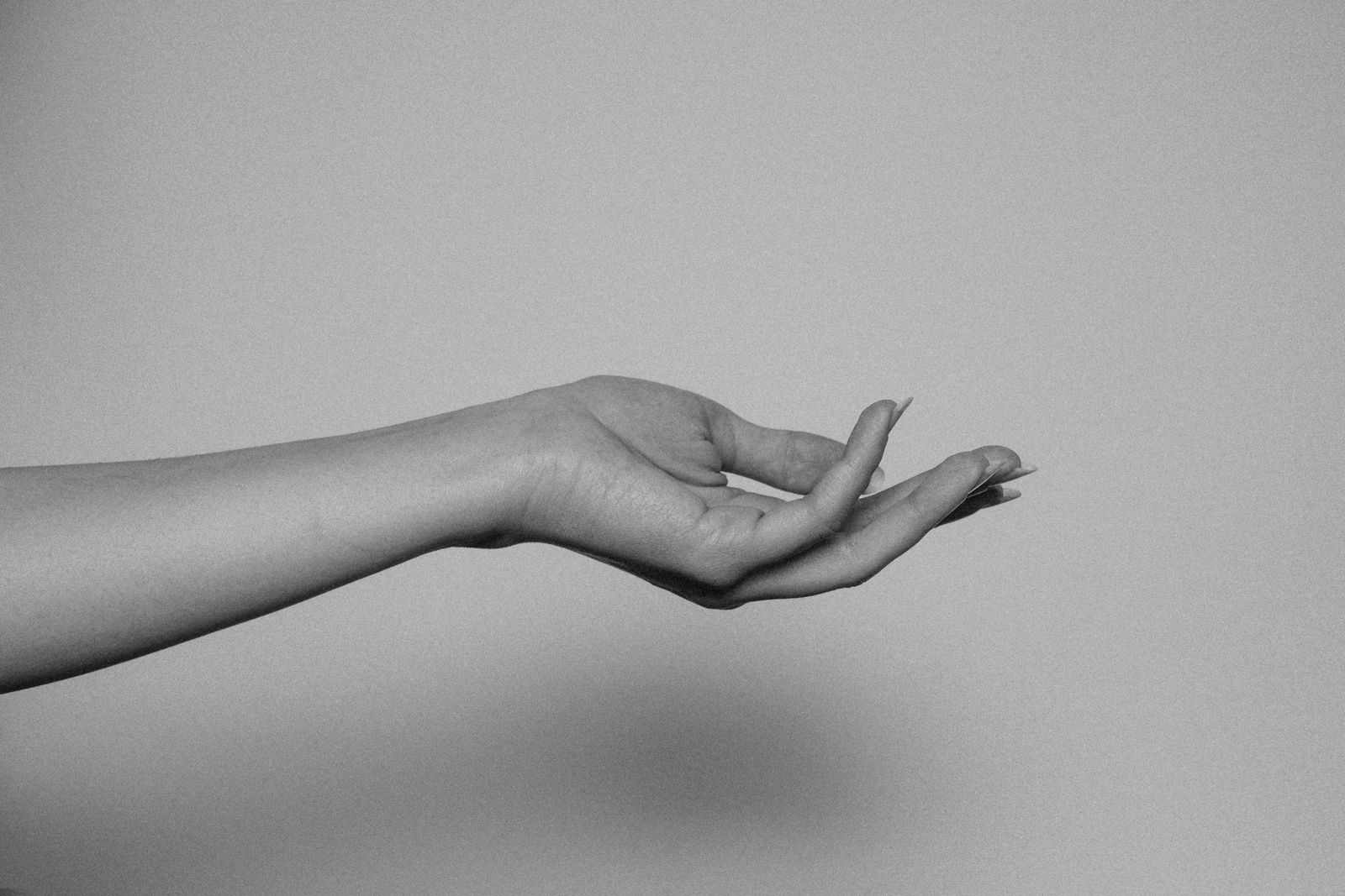 An outstretched inner forearm and open hand