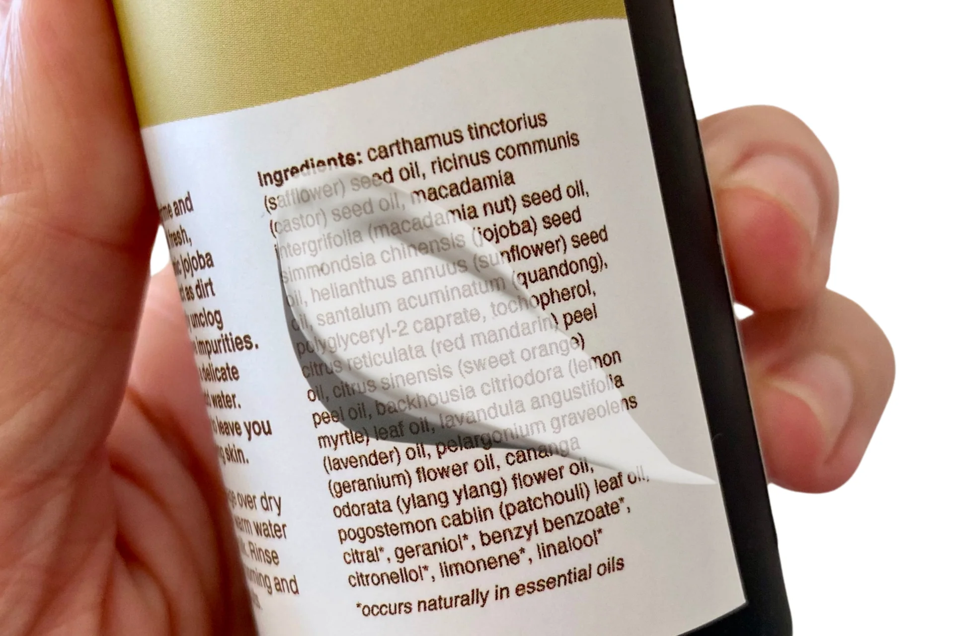 Person reading the ingredient list on a skincare product