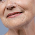 Close-up of a mature woman's lower face and neck showing natural skin texture