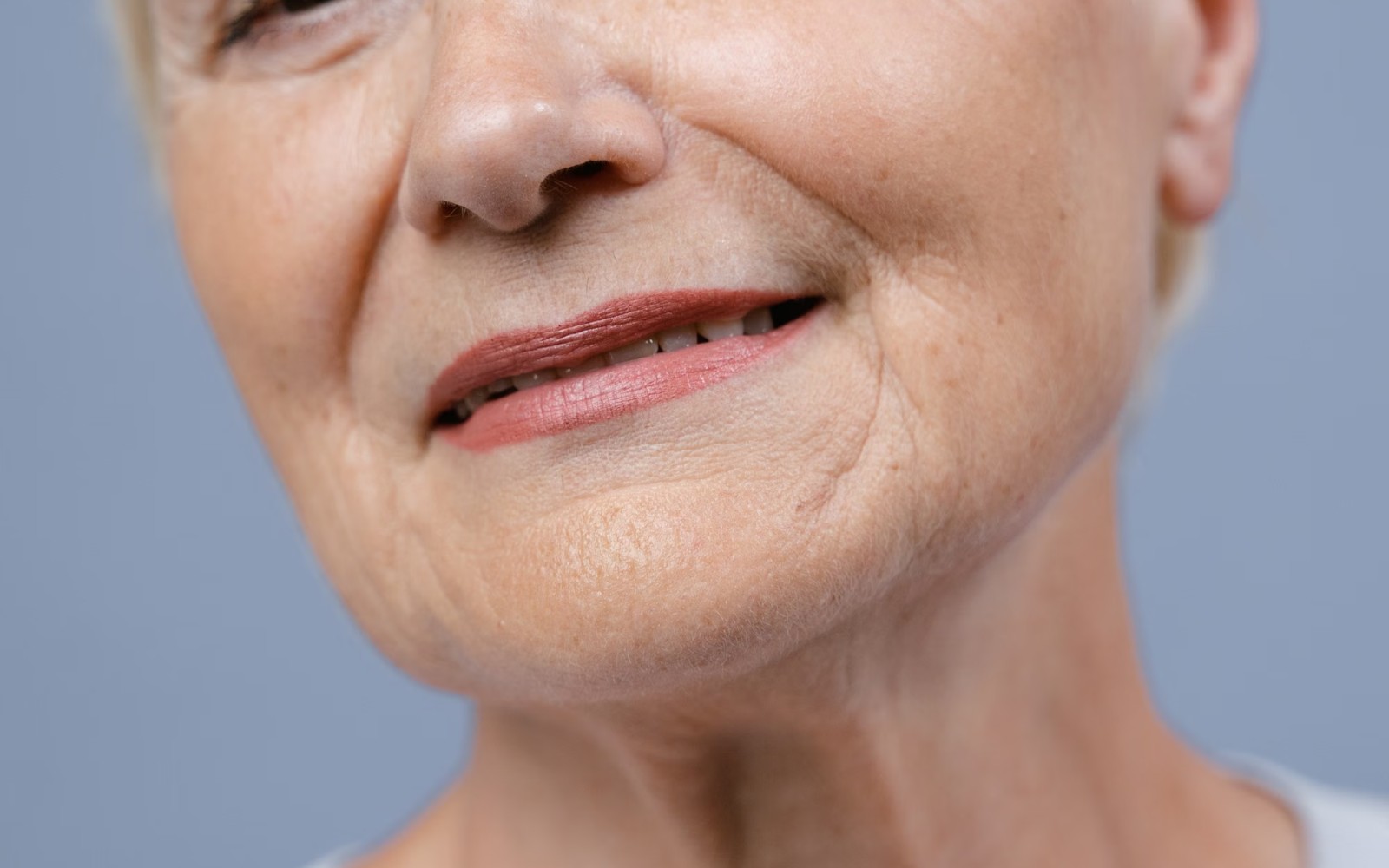 Close-up of a mature woman's lower face and neck showing natural skin texture