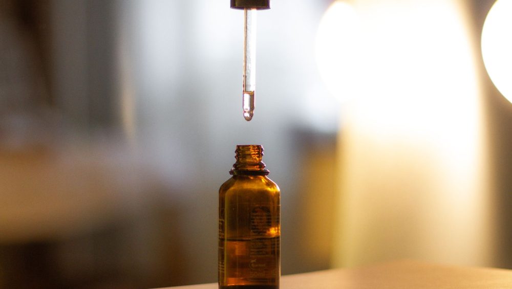 Two serum bottles side by side, one peptide and one retinoid