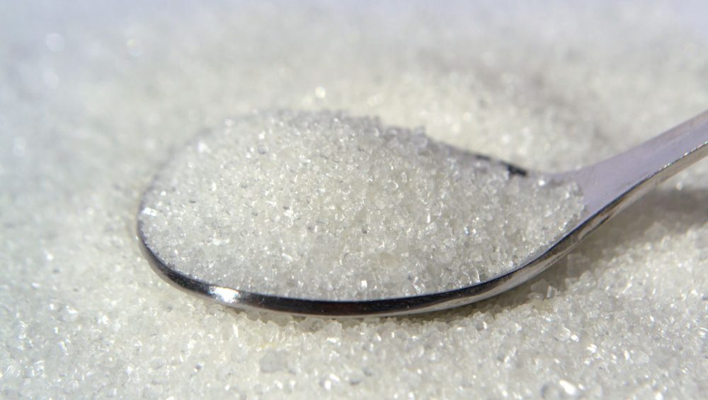 A spoonful of fine sugar crystals