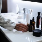 Skincare products stored on a bathroom shelf