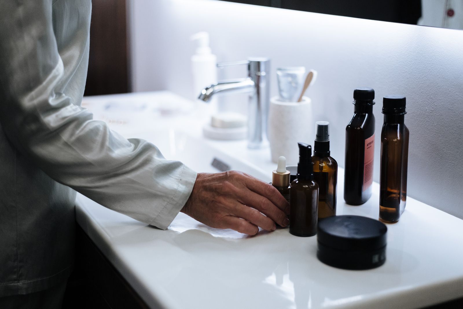 Skincare products stored on a bathroom shelf