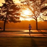 Runner in a park at sunrise
