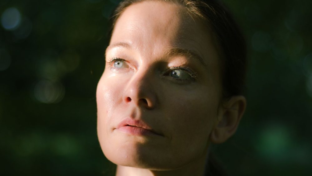 Portrait of a woman in natural light, a soft sheen on the forehead and nose