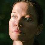 Portrait of a woman in natural light, a soft sheen on the forehead and nose