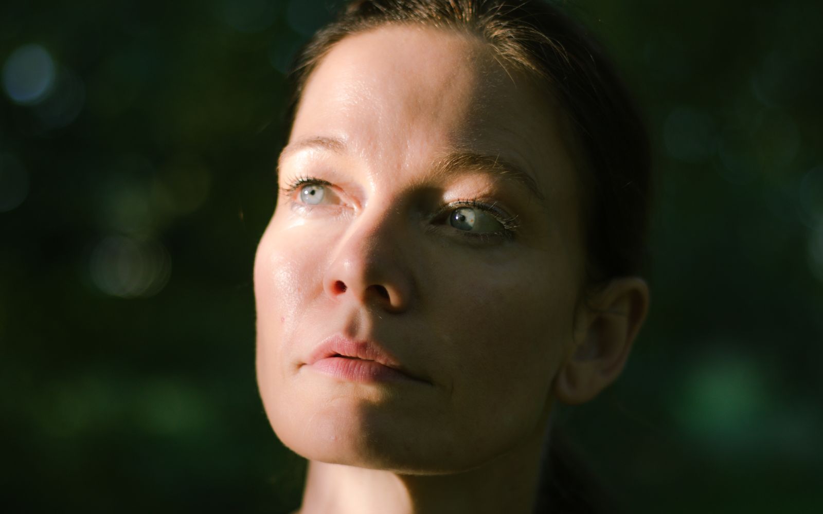 Portrait of a woman in natural light, a soft sheen on the forehead and nose