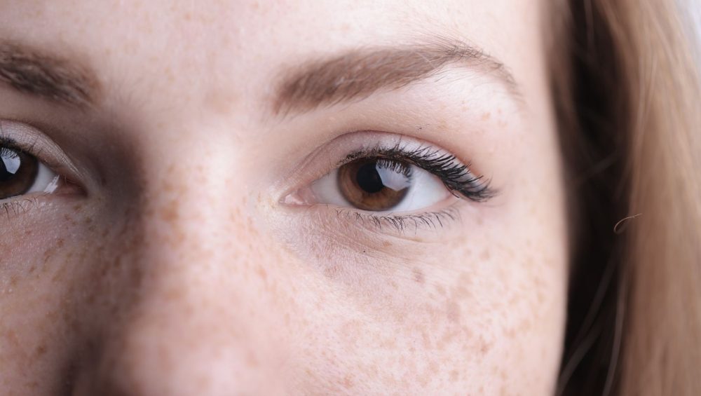 Close-up of a woman's eye area without makeup, soft natural light